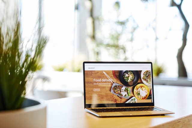 Laptop displaying a food delivery service website, a potential use case for Pay Monthly Websites for Coventry.