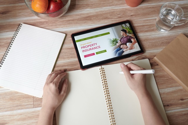 Person using a tablet to view a property insurance website, perfect for Pay Monthly Websites for Coventry.